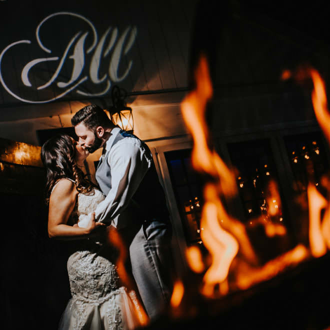 bride and groom night shot with fire