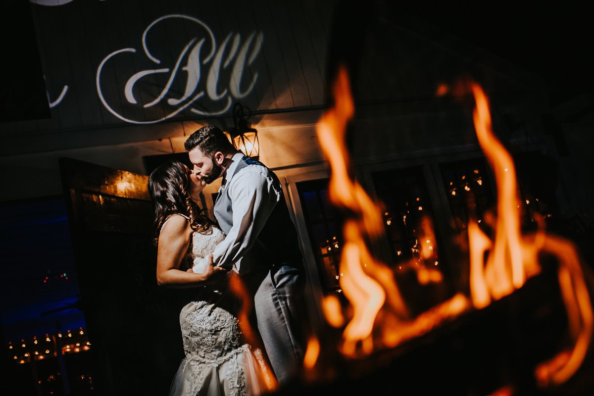 bride and groom night shot with fire