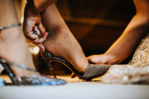 bride getting shoes on